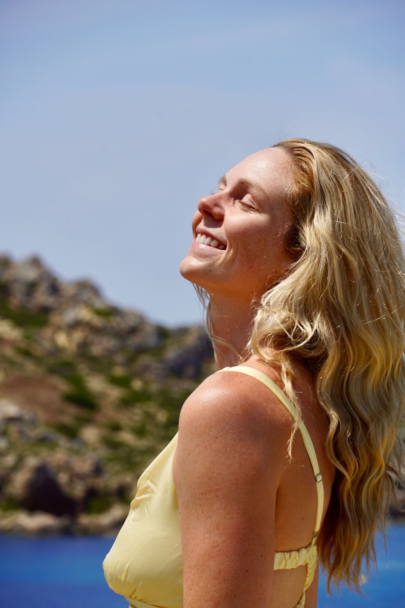 Cece smiling near the sea